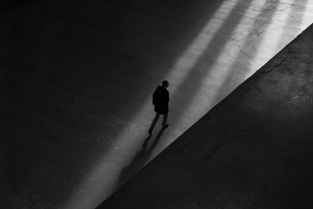 silhouette of a person walking alone