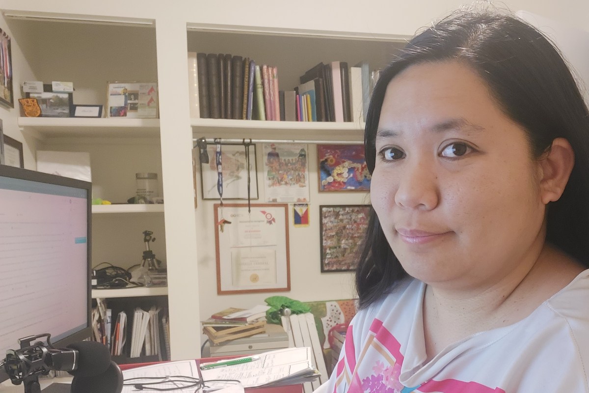 Giselle in her home office sitting by her computer desk.