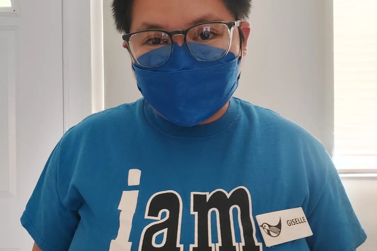 Giselle wearing a stylish safety glasses, KN95 mask and a volunteer Tshirt
