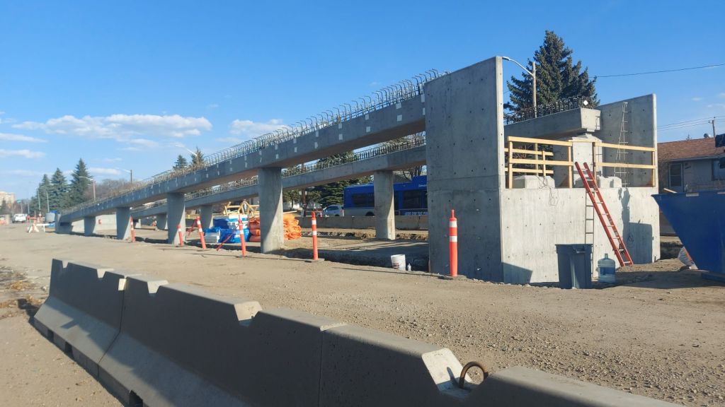The construction zone for the West Edmonton LRT along 87 Ave. The ramp to take the tracks to street level is partially done, with lots of metal rebar sticking out. 