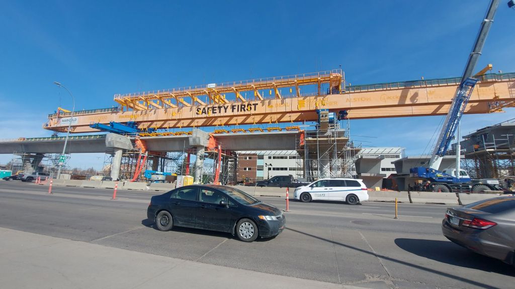 The construction zone for the West Edmonton LRT along 87 Ave. The specialized above-ground crane is lifting platforms for the above-ground Misericordia station. 