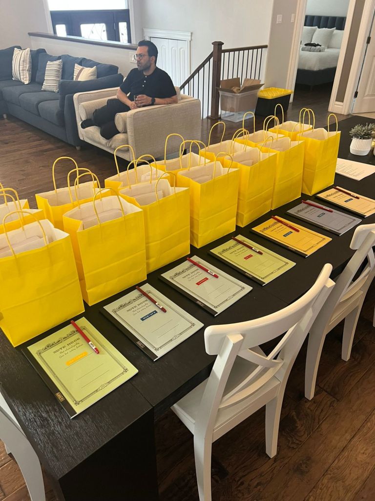 A table of gift bags and notebooks set up during the first night of the Nonfiction Writing Retreat. 