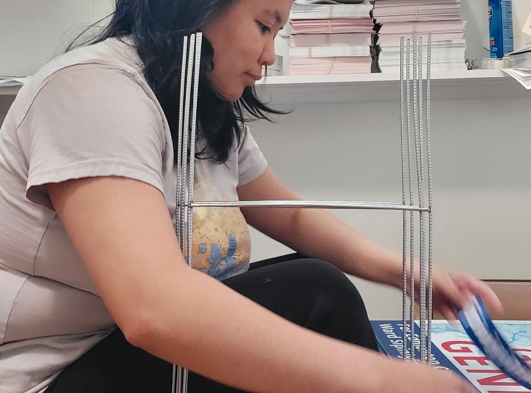 Giselle assembling lawn signs for the 2021 election campaign.